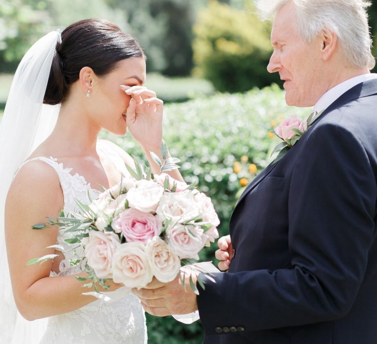 Emotional bride with her father before the church wedding ceremony