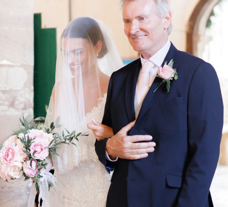 Father of the bride walking his daughter down the aisle