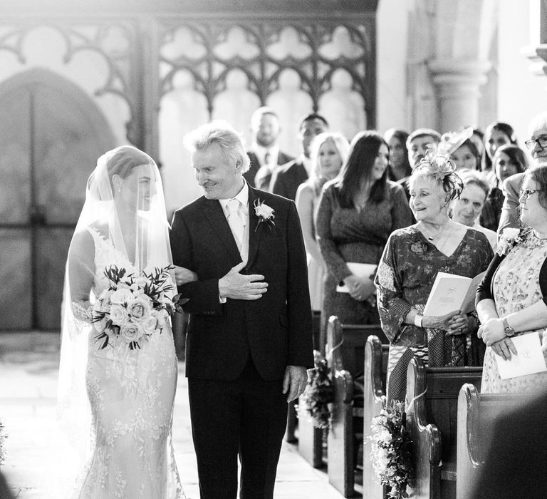 Father of the bride walking his daughter down the church aisle