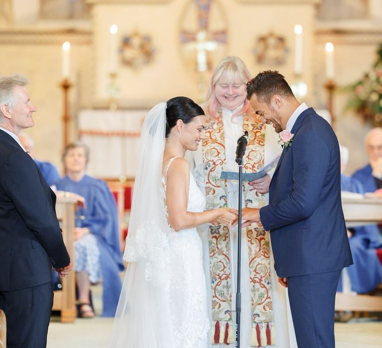 Bride and groom exchange vows at church wedding ceremony