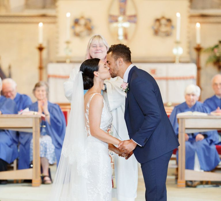 You may now kiss the bride moment at church wedding ceremony