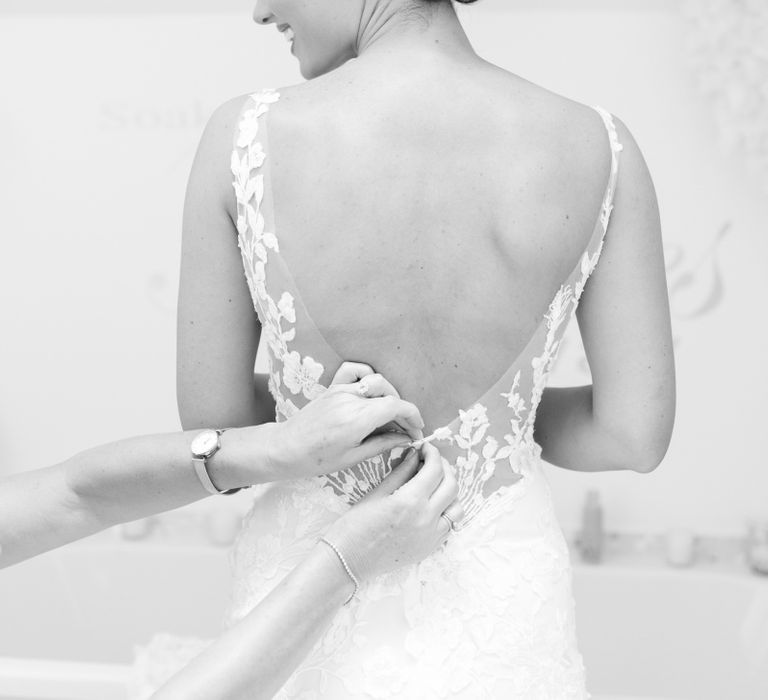 Bride with sleek bun a low back Pronovias wedding dress