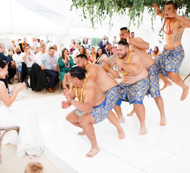 Groom and groomsmen performing a Samoan dance for the bride