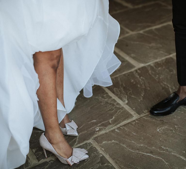 Gold glitter wedding shoes with bows at The Old Kent Barn wedding