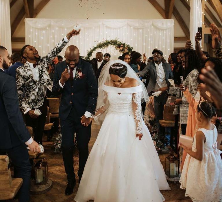 Bride and groom walking up the aisle as husband and wife