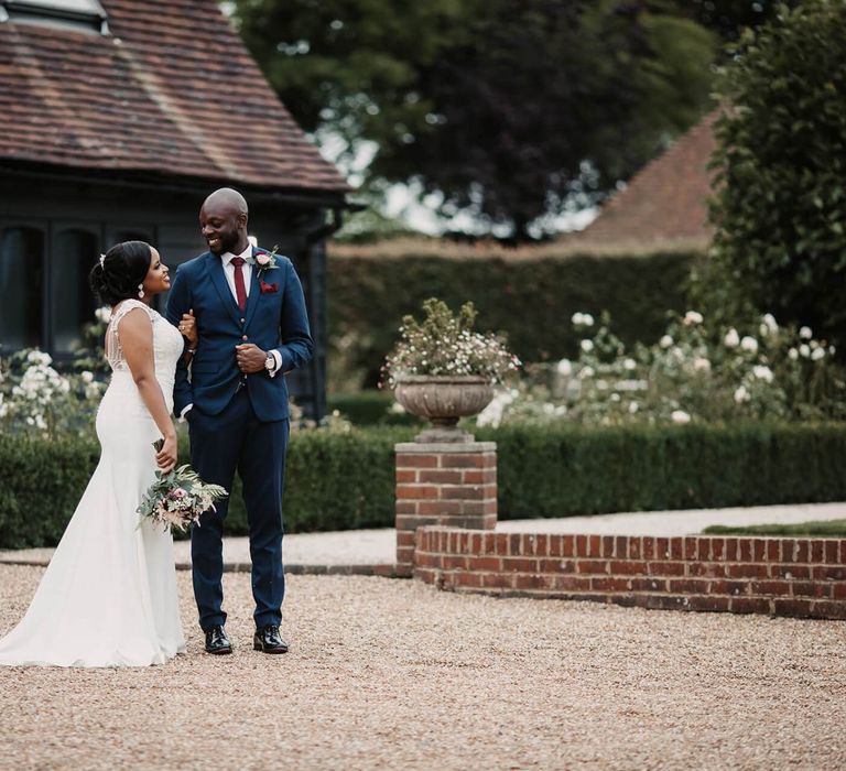 Bride and groom portraits in the courtyard of The Old Kent Barn