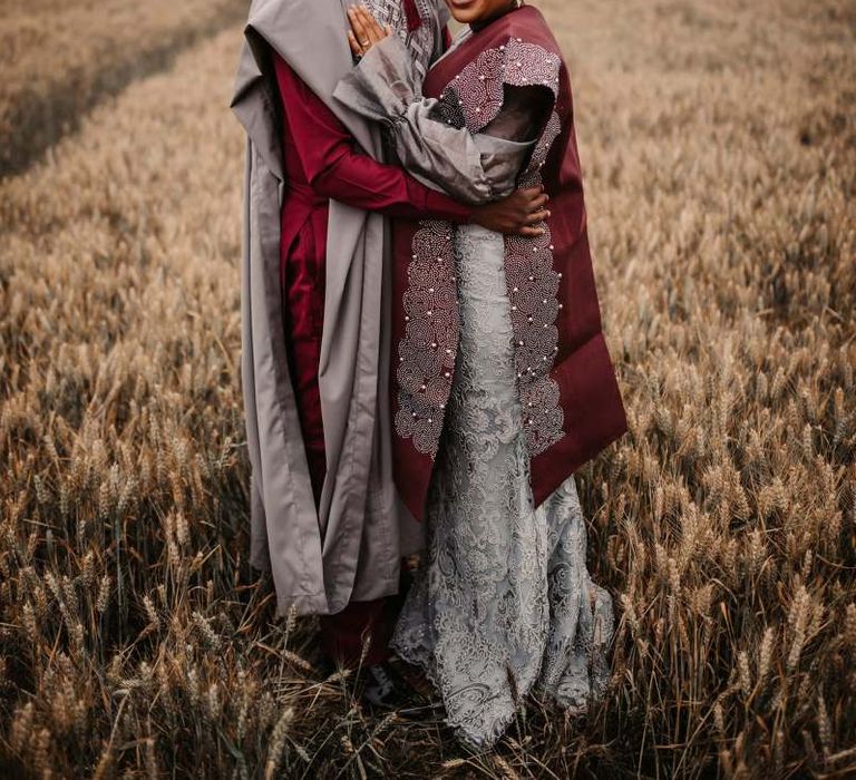 Bride and groom in traditional African wedding robes at The Old Kent Barn