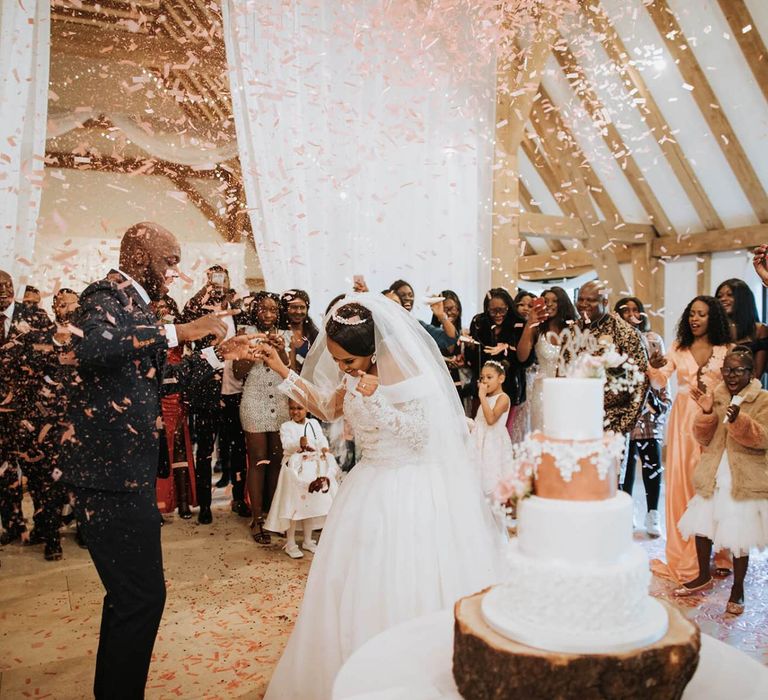 Bride and groom dancing under a confetti bomb