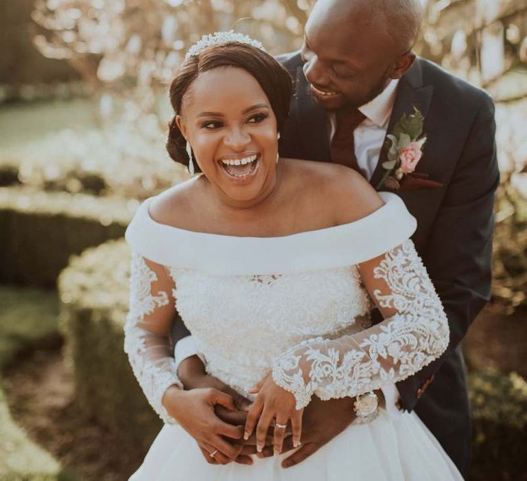 Beautiful bride in off the shoulder wedding dress with long sleeves at The Old Kent Barn wedding