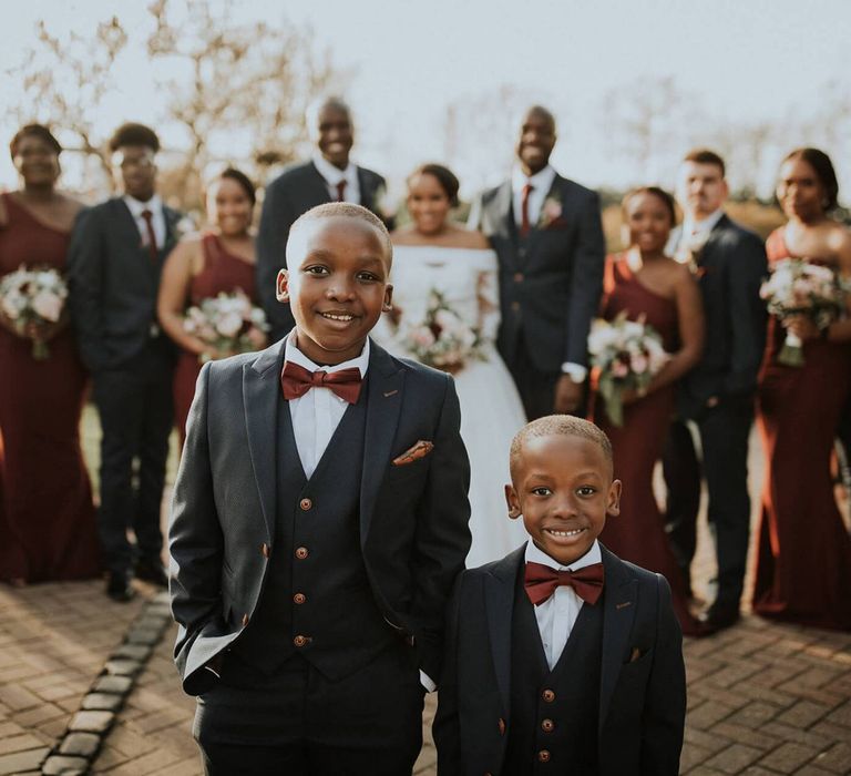 Page Boys in navy suits and burgundy ties like the groomsmen