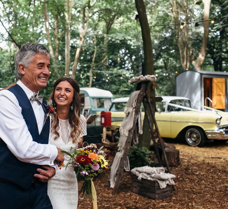 Bride in Lenora Dress by Wtoo Watters with Lace Cap Sleeves and Keyhole Back | Father of the Bride in Blue Waistcoat, Trousers and Bow Tie | Colourful Bridal Bouquet with Sunflowers and Yellow Trailing Ribbon | Vintage 957 Yellow Chevrolet Station Wagon | Woodland Wedding Ceremony at Lila's Wood | Macrame Decor, Vintage Caravan Photobooth and Five-Tier Naked Wedding Cake for Boho Wedding in Woodlands | Freckle Photography