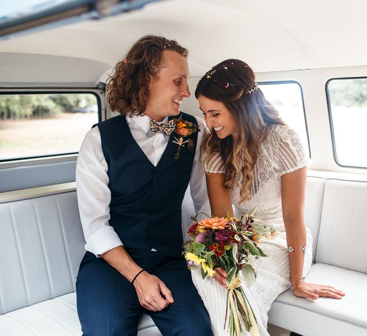 Bride in Lenora Dress by Wtoo Watters with Lace Cap Sleeves and Keyhole Back | Groom in Blue Waistcoat and Trousers with Colourful Patterned Bow Tie |  Colourful Bridal Bouquet with Sunflowers and Yellow Trailing Ribbon | Macrame Decor, Vintage Caravan Photobooth and Five-Tier Naked Wedding Cake for Boho Wedding in Woodlands | Freckle Photography