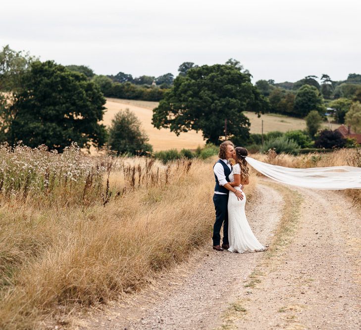 Bride in Lenora Dress by Wtoo Watters with Lace Cap Sleeves and Keyhole Back | Groom in Blue Waistcoat and Trousers with Colourful Patterned Bow Tie | Macrame Decor, Vintage Caravan Photobooth and Five-Tier Naked Wedding Cake for Boho Wedding in Woodlands | Freckle Photography