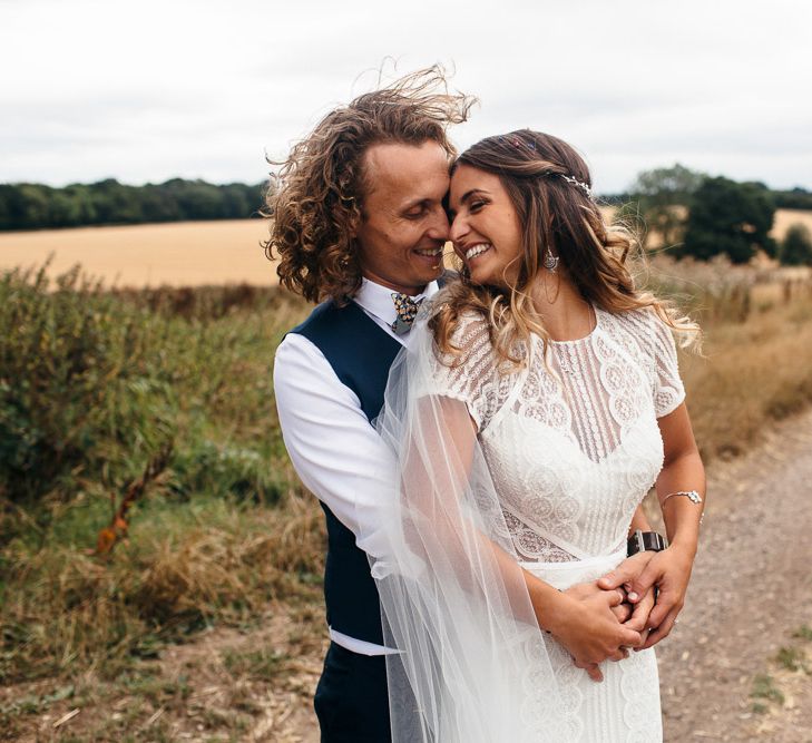 Bride in Lenora Dress by Wtoo Watters with Lace Cap Sleeves and Keyhole Back | Groom in Blue Waistcoat and Trousers with Colourful Patterned Bow Tie | Macrame Decor, Vintage Caravan Photobooth and Five-Tier Naked Wedding Cake for Boho Wedding in Woodlands | Freckle Photography