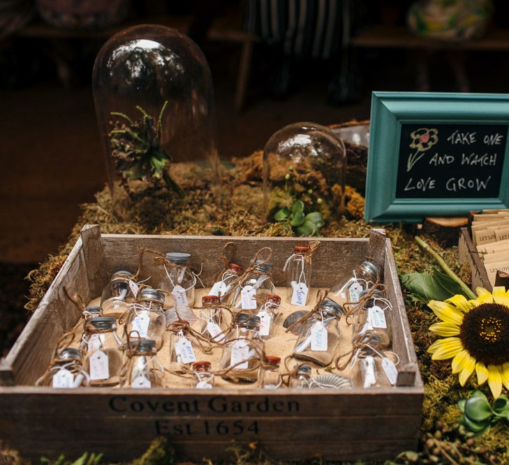 Wooden Crate Filled with Sand and Bottles | Message in a Bottle | Packets of Seeds | Macrame Decor, Vintage Caravan Photobooth and Five-Tier Naked Wedding Cake for Boho Wedding in Woodlands | Freckle Photography