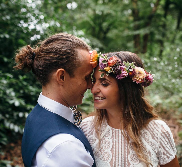 Bride in Lenora Dress by Wtoo Watters with Lace Cap Sleeves and Keyhole Back | Groom in Blue Waistcoat and Trousers with Colourful Patterned Bow Tie | Colourful Flower Crown |  Macrame Decor, Vintage Caravan Photobooth and Five-Tier Naked Wedding Cake for Boho Wedding in Woodlands | Freckle Photography