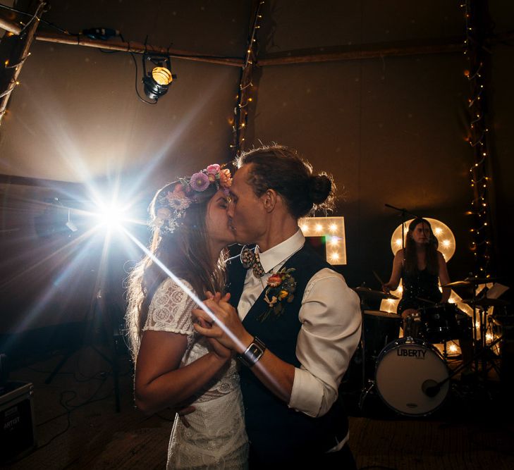 Bride in Lenora Dress by Wtoo Watters with Lace Cap Sleeves and Keyhole Back | Groom in Blue Waistcoat and Trousers with Colourful Patterned Bow Tie | Colourful Flower Crown | First Dance in Tipi at Lila's Wood | Macrame Decor, Vintage Caravan Photobooth and Five-Tier Naked Wedding Cake for Boho Wedding in Woodlands | Freckle Photography