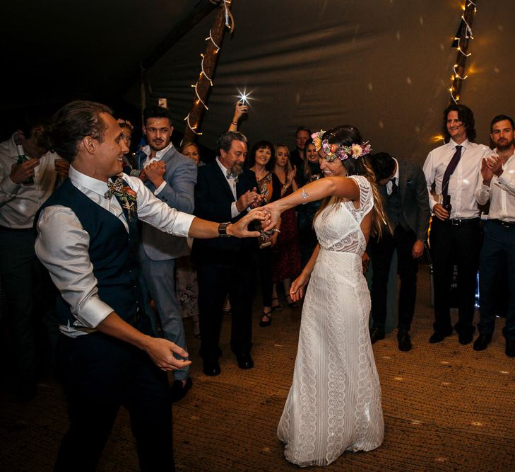 Bride in Lenora Dress by Wtoo Watters with Lace Cap Sleeves and Keyhole Back | Groom in Blue Waistcoat and Trousers with Colourful Patterned Bow Tie | Colourful Flower Crown | First Dance in Tipi at Lila's Wood | Macrame Decor, Vintage Caravan Photobooth and Five-Tier Naked Wedding Cake for Boho Wedding in Woodlands | Freckle Photography