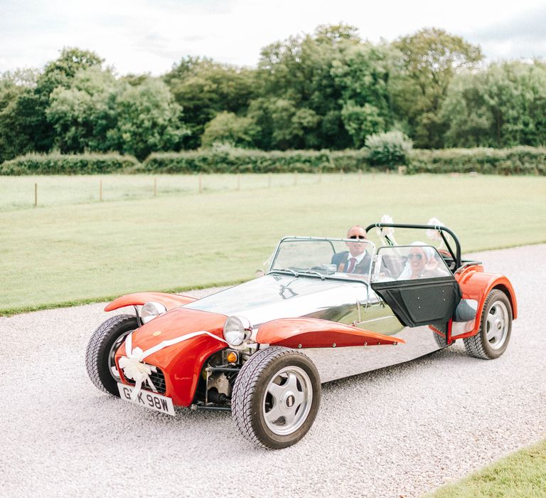 Red Kit Car Decorated with Ribbon | Arrival of the Bride | Hazel Gap Barn Wedding with Bride Arriving by Kit Car | Sarah-Jane Ethan Photography