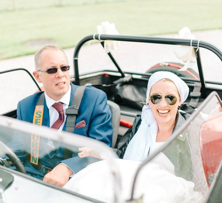 Red Kit Car Decorated with Ribbon | Arrival of the Bride | Bride in Leather Jacket, Headscarf and Aviator Sunglasses | Father of the Bride in Blue Suit | Hazel Gap Barn Wedding with Bride Arriving by Kit Car | Sarah-Jane Ethan Photography