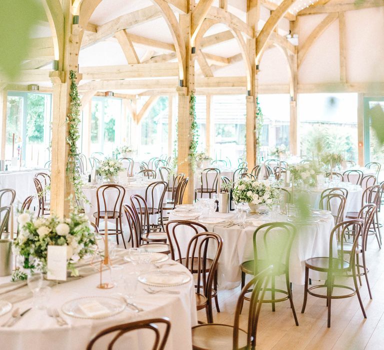 Wedding Reception Decor | Round Tables | Fairy Lights | White Flowers and Green Foliage |  Hazel Gap Barn Wedding with Bride Arriving by Kit Car | Sarah-Jane Ethan Photography