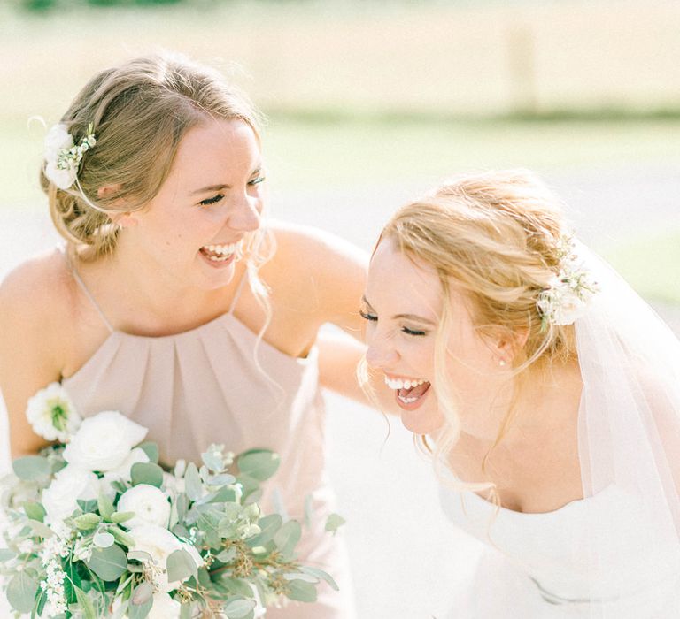 Bride in Strapless Sassi Holford Ballgown Wedding Dress with Belt | Bridesmaid in Grey Halterneck Dress | Loose Bouquets of White Flowers and Foliage | Hazel Gap Barn Wedding with Bride Arriving by Kit Car | Sarah-Jane Ethan Photography