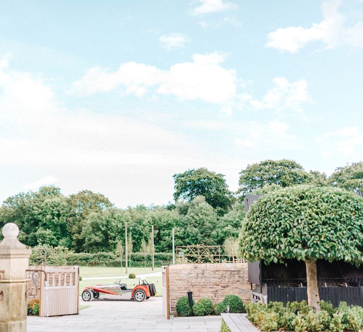 Hazel Gap Barn | Red Kit Car | Hazel Gap Barn Wedding with Bride Arriving by Kit Car | Sarah-Jane Ethan Photography