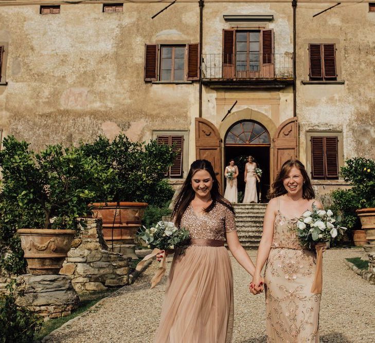 Bridesmaids Walking Down the Aisle in Pink and Rose Gold Dresses