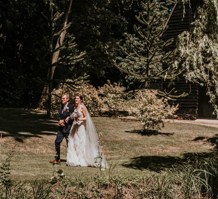 Outdoor Wedding Ceremony Bridal Entrance  in Pronovias Danaia Wedding Dress