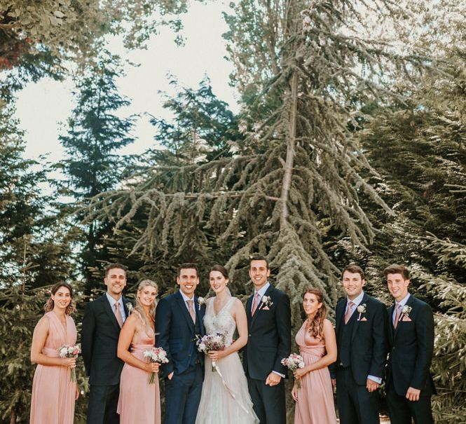 Wedding Party Portrait with Bridesmaids in Pink Dresses, Bride in Pronovias Wedding Dress and Groomsmen in Navy Suits