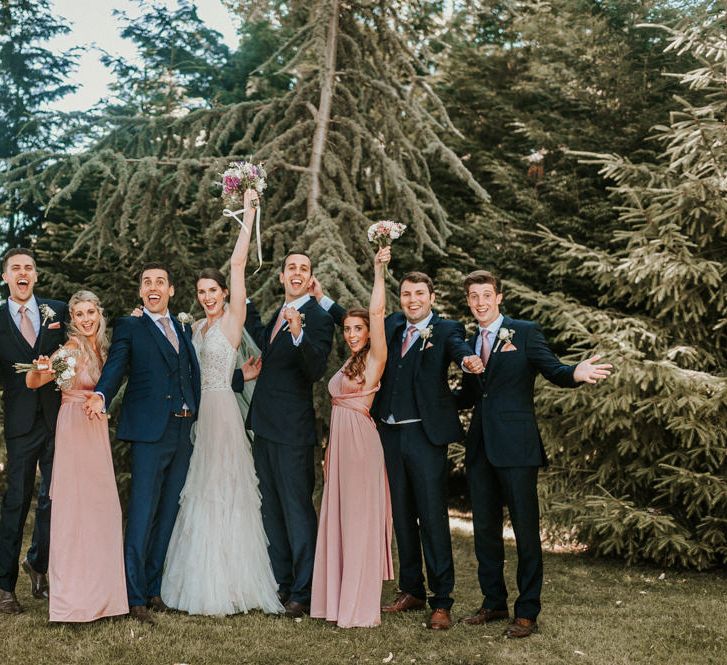 Wedding Party Portrait with Bridesmaids in Pink Oasis Dresses, Bride in Pronovias Wedding Dress and Groomsmen in Navy Moss Bros Suits