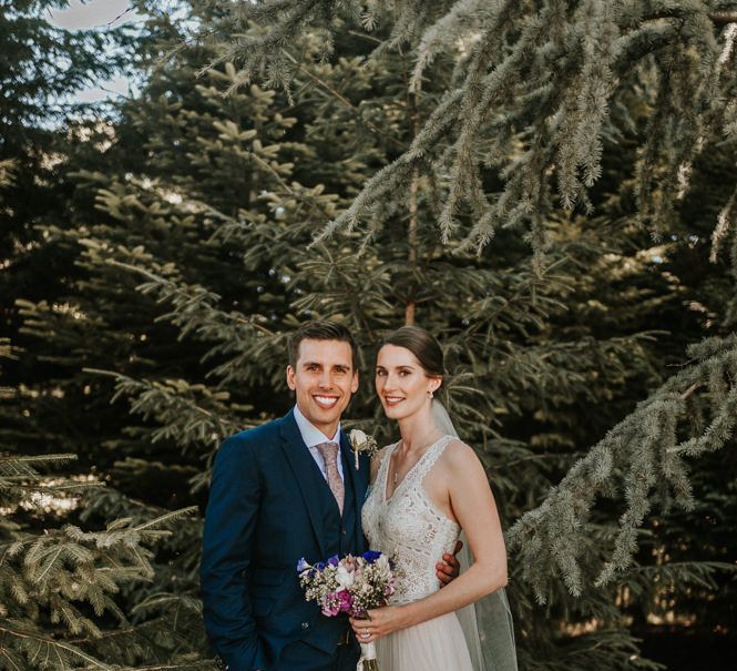 Portrait of Bride in Pronovias Danaia Wedding Dress and Groom in Navy Moss Bros. Suits