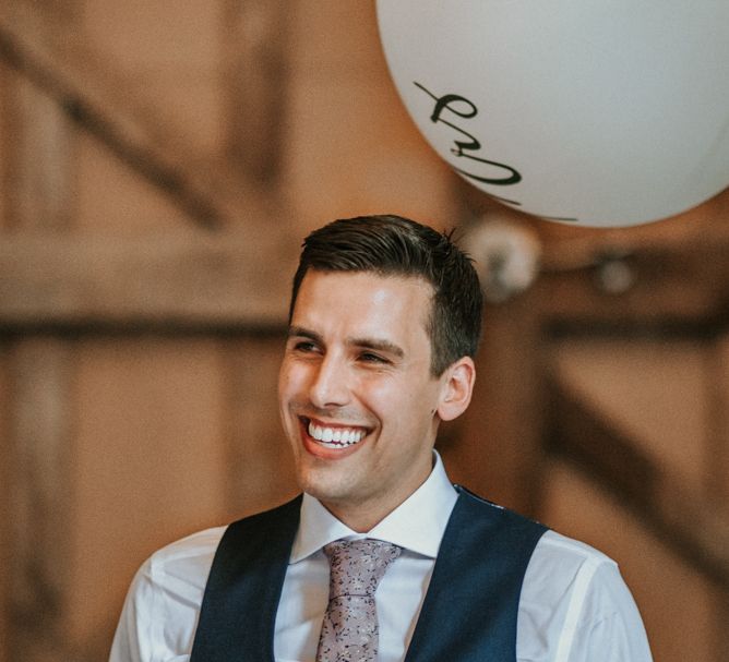 Smiley Groom in Navy Waistcoat and Paisley Tie