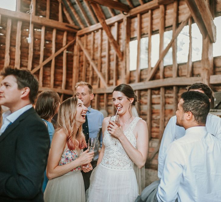 Bride in Pronovias Danaia Wedding Dress Enjoying Drinks Reception in Barn