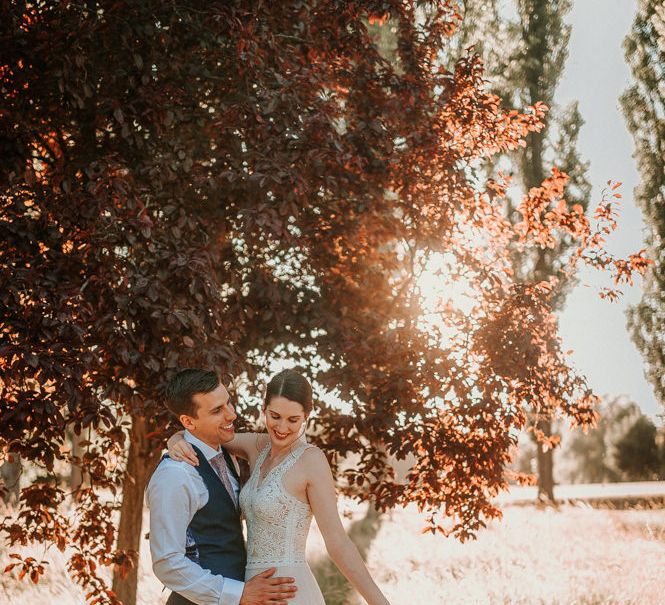 Golden Hour Portrait with Bride in Pronovias Danaia Wedding Dress and Groom in Navy Waistcoat