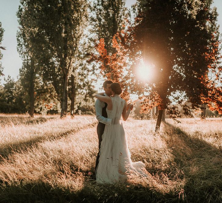 Golden Hour Field Portrait with Bride in Pronovias Danaia Wedding Dress and Groom in Moss Bros. Suit