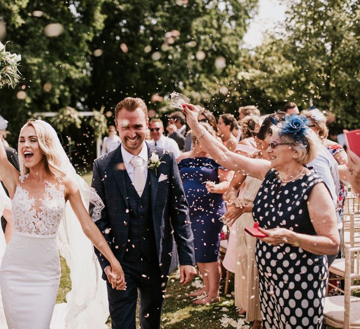 Confetti Moment with Bride in Pronovias Wedding Dress and Groom in Moss Bros. Suit