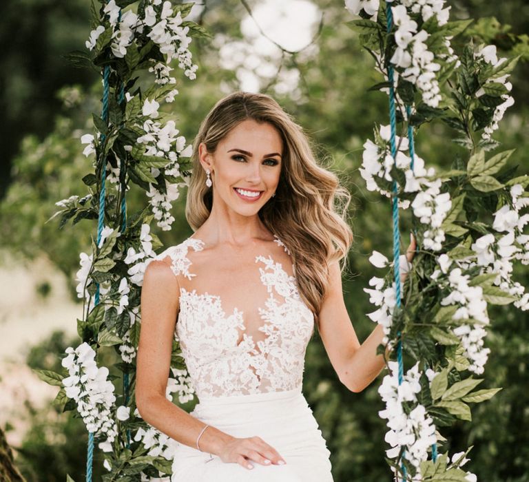 Bride in Pronovias Wedding Dress Sitting on a Ivy Covered Swing