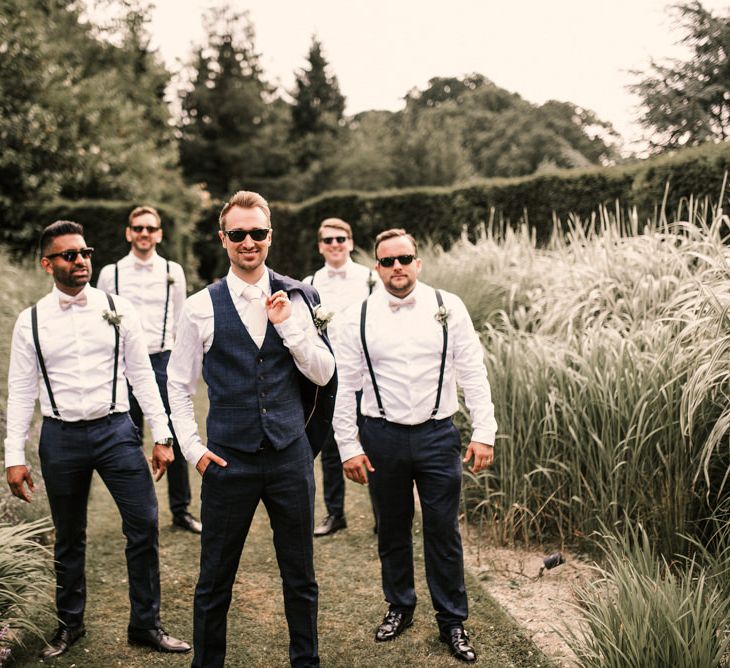 Stylish Groomsmen in Braces and Groom in Check Moss Bros. Suit