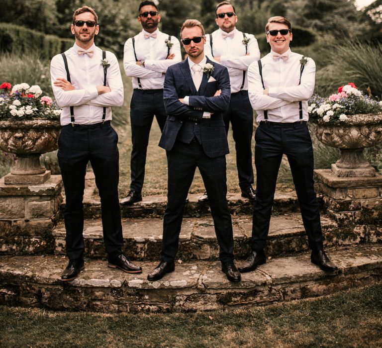 Stylish Groomsmen in Braces and Groom in Check Moss Bros. Suit