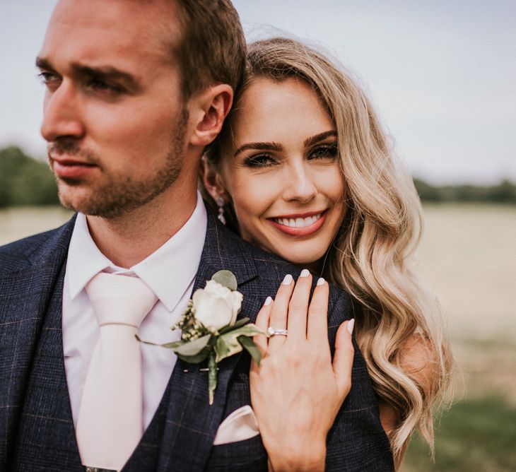 Beautiful Bride and Groom Embracing in Field