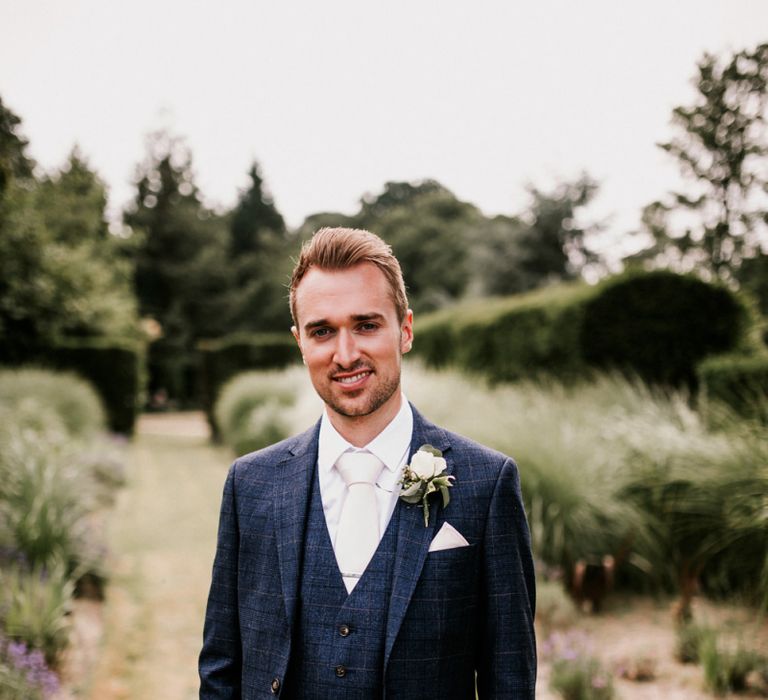 Groom in Navy Check Moss Bros Suit