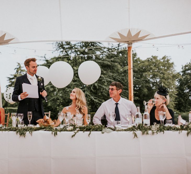 Groom in Navy Check Moss Bros Suit  Giving Speech During Wedding Reception