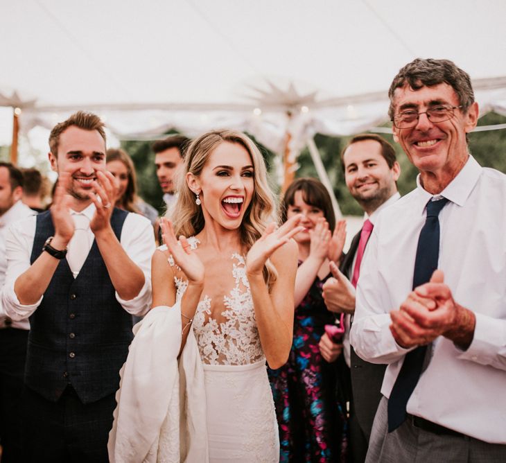 Bride and Groom Laughing During Wedding Entertainment