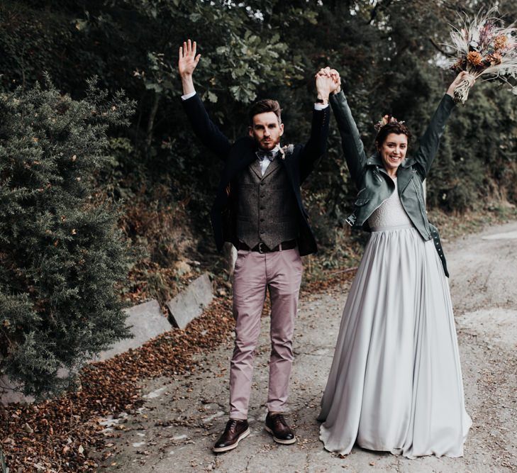 Bride in Mila Mira Separates with Silver Skirt and Leather Jacket and Groom in Pink Chinos, Wool Waistcoat and Navy Blazer