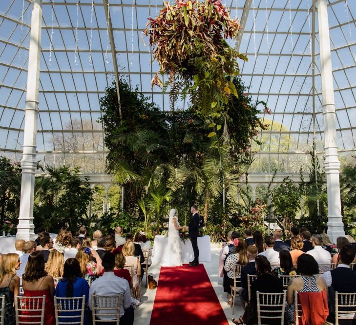 Wedding ceremony in Liverpool glass house with white bridesmaid dresses