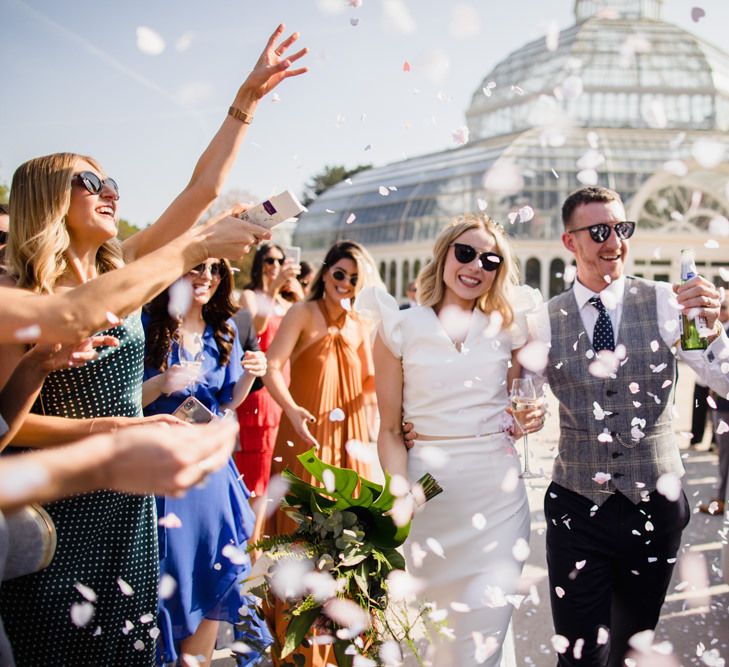 Confetti exit for bride and groom with white bridesmaid dresses