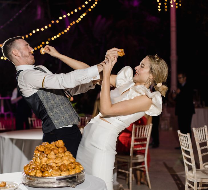 Bride and groom feed each other cake