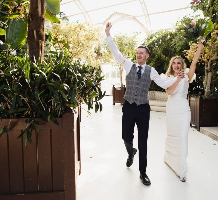 Bride and groom celebrate their wedding with white bridesmaid dresses