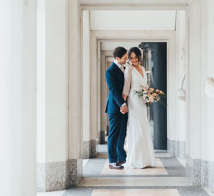 Bride and Groom Embrace at City Wedding